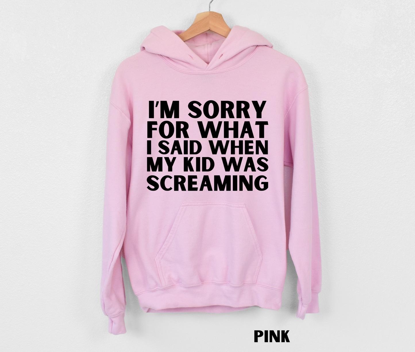 Light pink funny mom hoodie with the text "I'm sorry for what I said when my kid was screaming" in black.