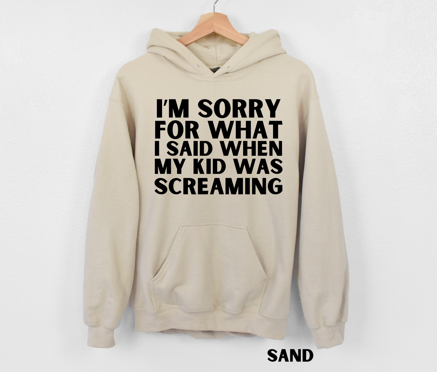 Sand funny mom hoodie with the text "I'm sorry for what I said when my kid was screaming" in black.