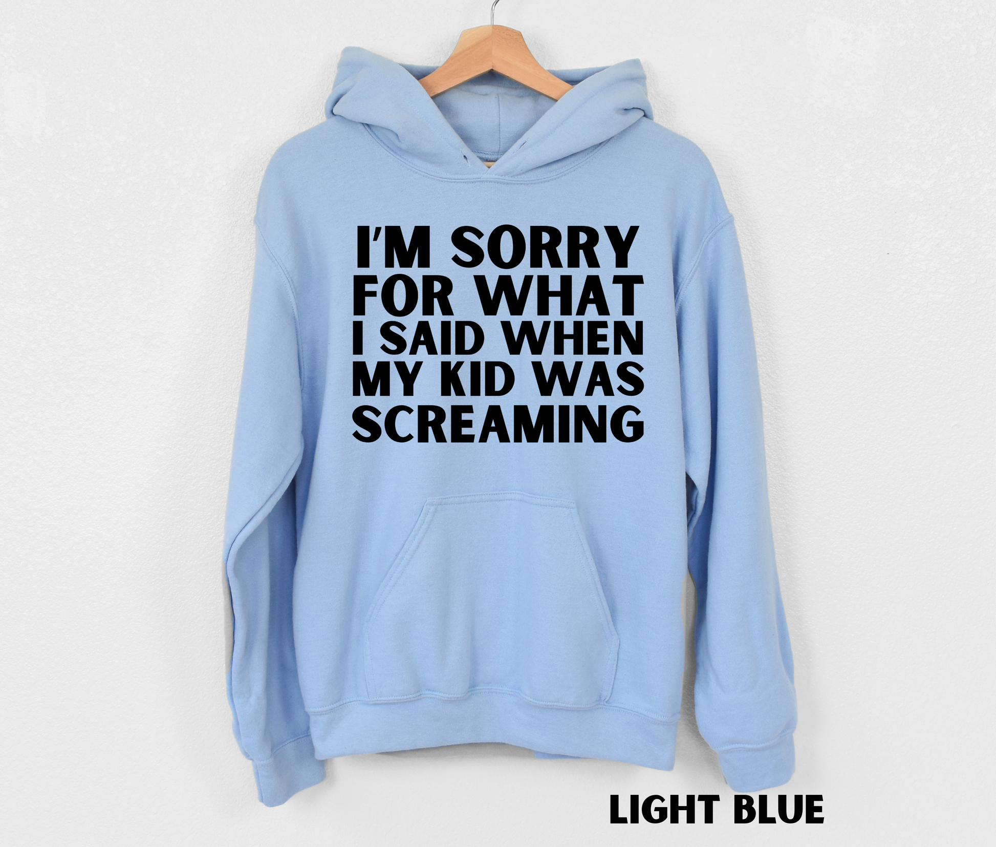 Light blue funny mom hoodie with the text "I'm sorry for what I said when my kid was screaming" in black.